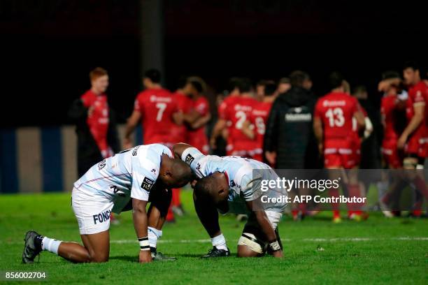 Racing Metro 92's players react at the end of the French Top 14 rugby union match between Racing Metro 92 and Lyon Olympique Universitaire on...