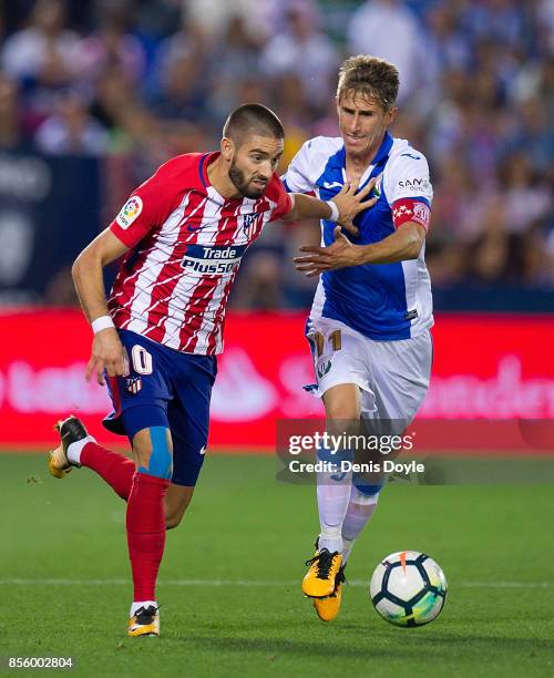 Yannick Carrasco of Club Atletico de Madrid fends off Alexander Szymanowski of CD Leganes during the La Liga match between Leganes and Atletico...