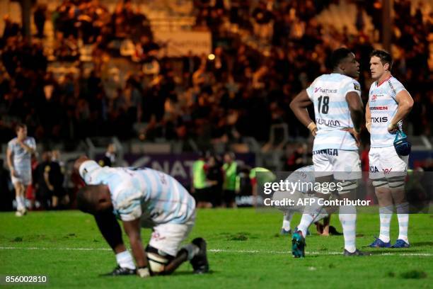 Racing Metro 92's players react at the end of the French Top 14 rugby union match between Racing Metro 92 and Lyon Olympique Universitaire on...
