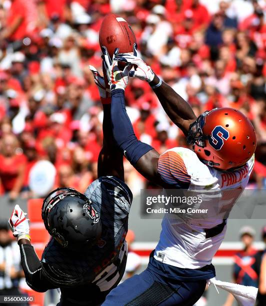 Safety Tim Kidd-Glass of the North Carolina State Wolfpack breaks up a pass intended for wide receiver Ervin Philips of the Syracuse Orange in the...