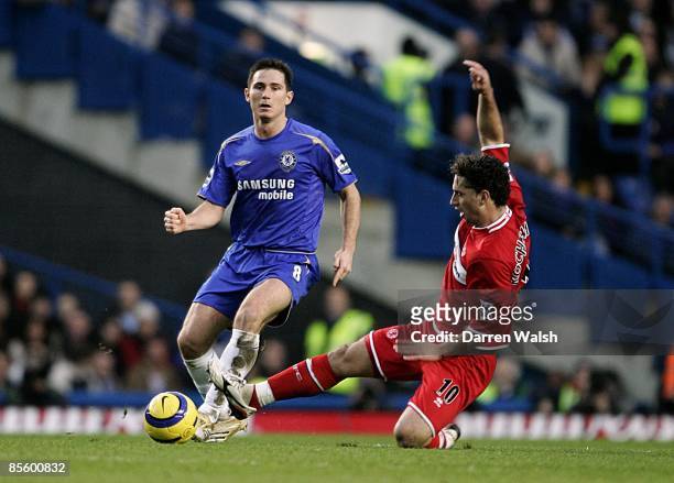 Middlesbrough's Fabio Rochemback slides in to control the ball ahead of Chelsea's Frank Lampard