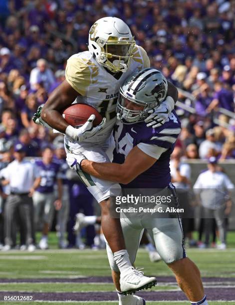 Linebacker Tanner Wood of the Kansas State Wildcats tackles wide receiver Tony Nicholson of the Baylor Bears during the first half on September 30,...