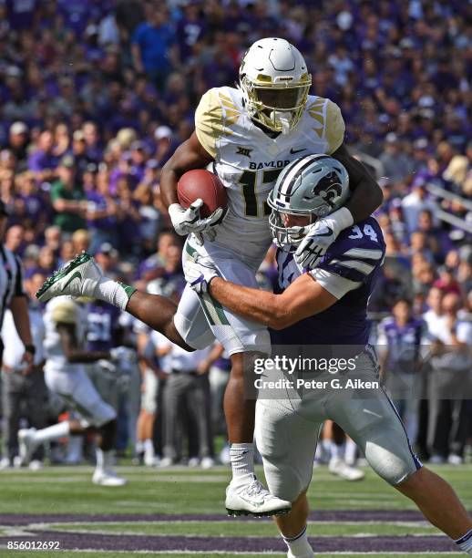 Linebacker Tanner Wood of the Kansas State Wildcats tackles wide receiver Tony Nicholson of the Baylor Bears during the first half on September 30,...