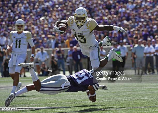 Free safety Kendall Adams of the Kansas State Wildcats trips up wide receiver Tony Nicholson of the Baylor Bears during the first half on September...