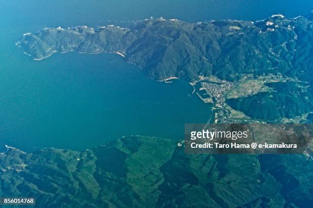 pacific ocean and kimotsuki town in kagoshima prefecture in japan daytime aerial view from airplane - kimotsuki stockfoto's en -beelden