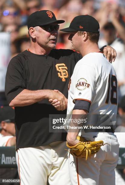 Matt Cain of the San Francisco Giants shakes the hand of manager Bruce Bochy as Bochy was taking Cain out of the game after the top of the fourth...