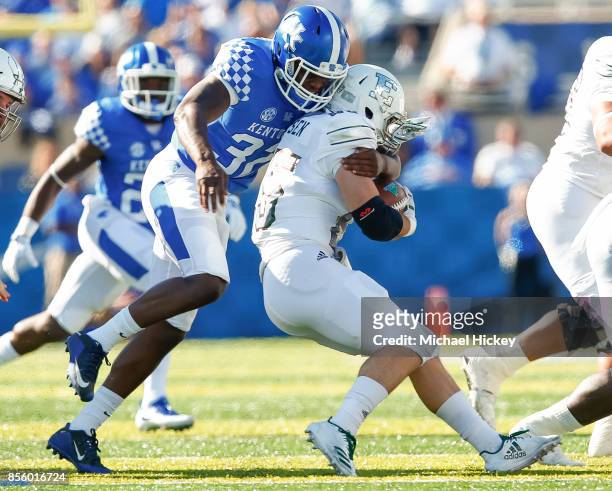 Eli Brown of the Kentucky Wildcats makes the stop as Ian Eriksen of the Eastern Michigan Eagles runs the ball at Commonwealth Stadium on September...