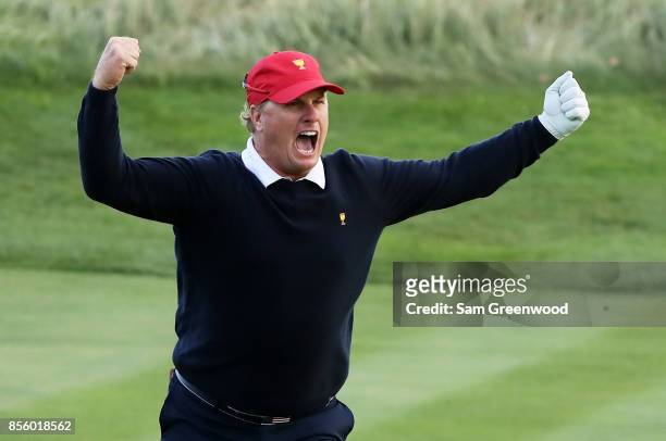 Charlie Hoffman of the U.S. Team reacts after chipping in on the 17th hole during Saturday four-ball matches of the Presidents Cup at Liberty...