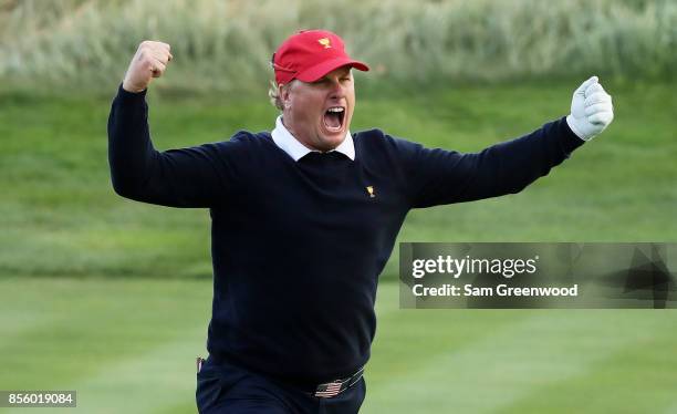 Charlie Hoffman of the U.S. Team reacts after chipping in on the 17th hole during Saturday four-ball matches of the Presidents Cup at Liberty...