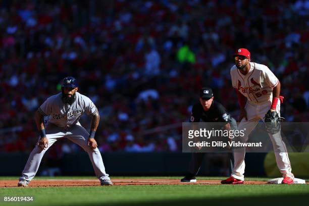 Eric Thames of the Milwaukee Brewers leads off first base against Jose Martinez of the St. Louis Cardinals in the third inning at Busch Stadium on...