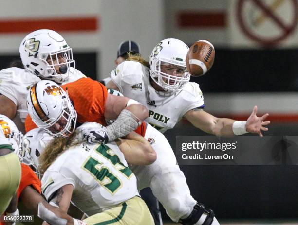 Linebacker Mason Montgomery of the Cal Poly Mustangs tries to grab a fumbled ball during first half action against the Idaho State Bengals on...