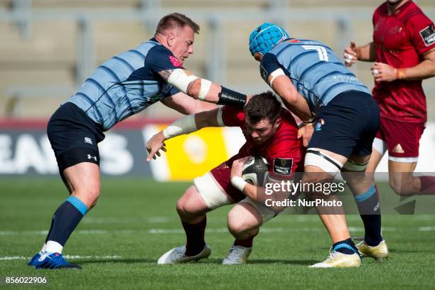 Peter O'Mahony of Munster tackled by Matthew Rees and Olly Robinson of Cardiff during the Guinness PRO14 Conference A Round 5 match between Munster...