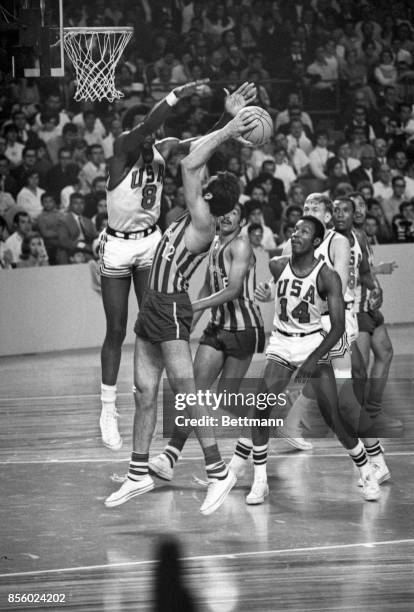 Basketball player Spencer Haywood is about to block a shot by Brazil’s Antonio Succas during Olympic action 10/22. The U.S. Beat Brazil 75-63 to...