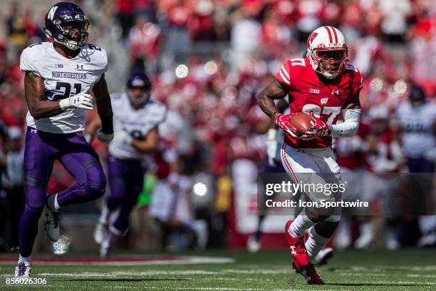 Wisconsin Badger wide receiver Quintez Cephus tries to run away from Northwestern Wildcats safety Kyle Queiro durning an college football game...
