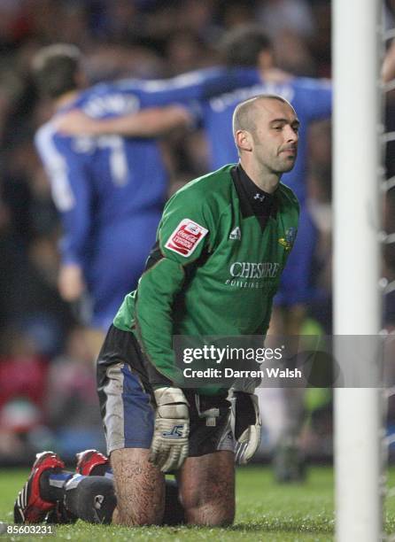 Macclesfield Town's replacement goalkeeper David Morley sits dejected as Chelsea's Frank Lampard scores his third goal