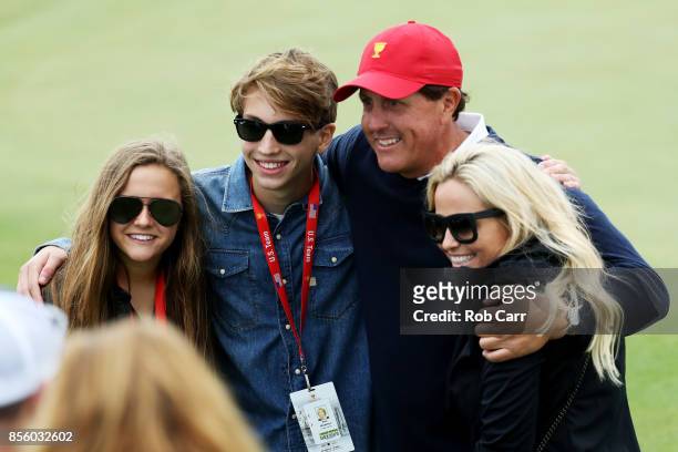 Phil Mickelson of the U.S. Team and his family, wife Amy, son Evan and daughter Sophia pose during Saturday four-ball matches of the Presidents Cup...