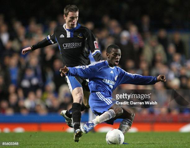 Chelsea's Shaun Wright-Phillips is challenged by Macclesfield Town's Kevin McIntyre as they battle for the ball
