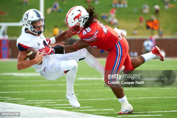 Anthony Rhone of the SMU Mustangs pushes Bryant Shirreffs of the Connecticut Huskies out of bounds during the second half at Gerald J. Ford Stadium...