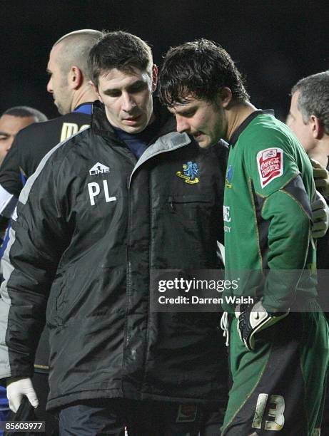 Macclesfield Town's Tommy Lee walks off the pitch with Physio Paul Lake after he was shown a red card after a challenge on Chelsea's Andriy Shevchenko