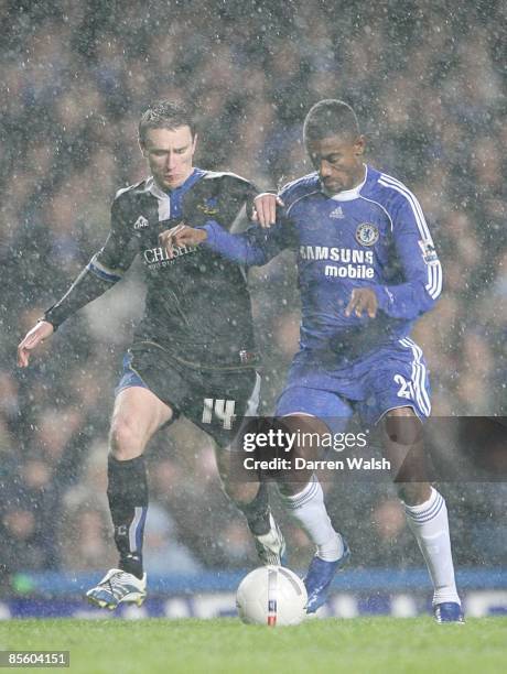 Macclesfield Town's Kevin McIntyre goes to foul Chelsea's Salomon Kalou