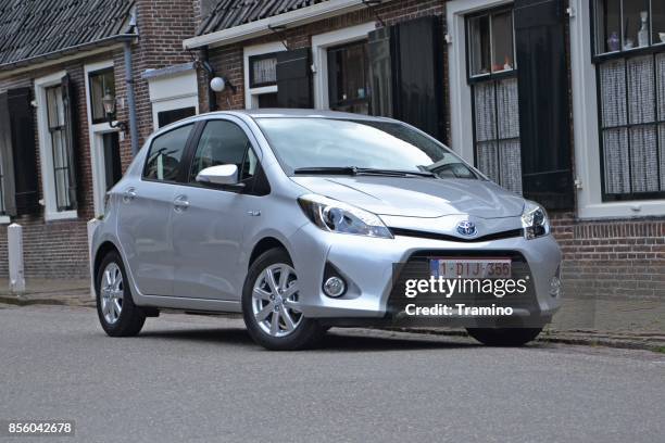 toyota yaris hybrid on the street - hatchback stock pictures, royalty-free photos & images