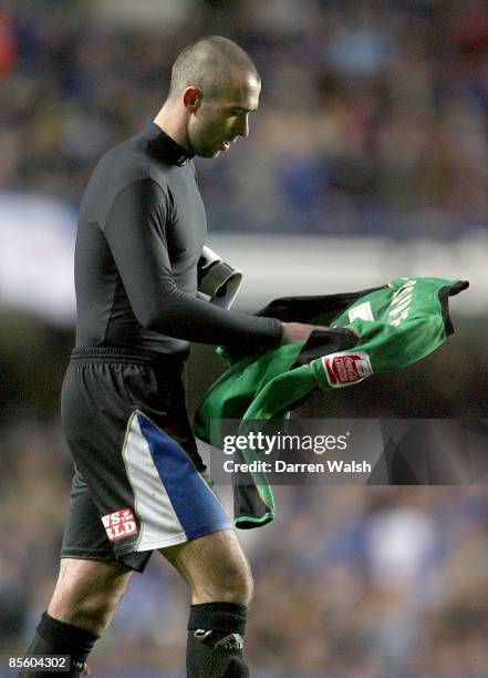 Macclesfield Town's David Morley puts on the goalkeepers shirt after Tommy Lee was dismissed after a challenge on Chelsea player Andriy Shevchenko