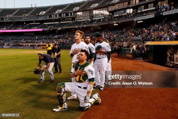 Bruce Maxwell of the Oakland Athletics kneels during the national anthem before the game against the Seattle Mariners at the Oakland Coliseum on...