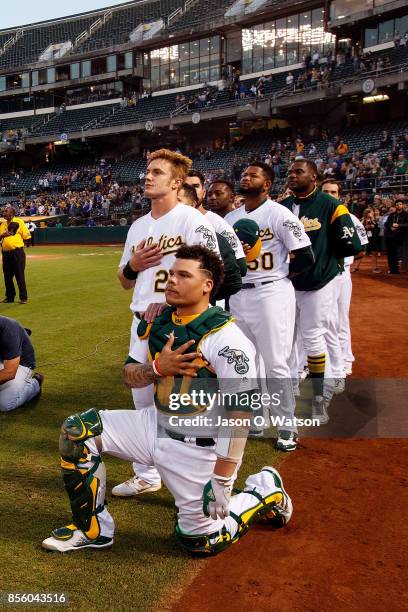 Bruce Maxwell of the Oakland Athletics kneels during the national anthem before the game against the Seattle Mariners at the Oakland Coliseum on...