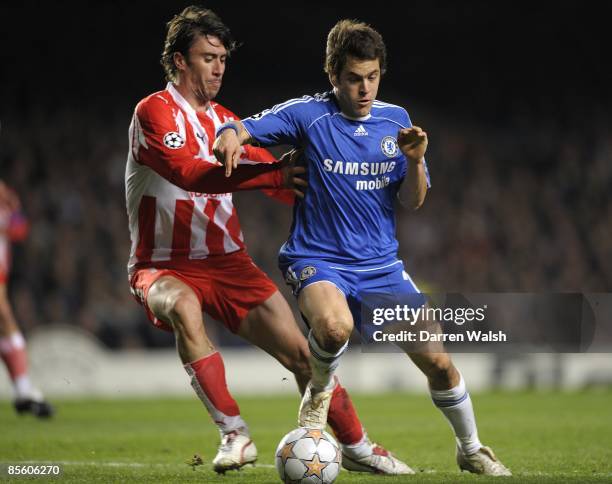 Olympiakos' Paraskevas Antzas and Chelsea's Joe Cole battle for the ball