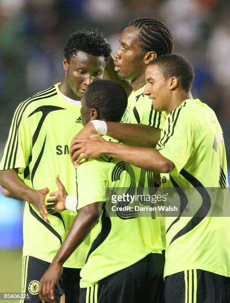 Chelsea's Jon Obi Mikel and Scott Sinclair congratulate Shaun Wright-Phillips on his pass to Didier Drogba who scored the opening goal