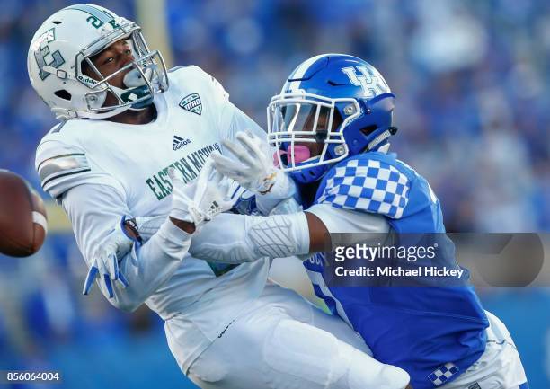 Antoine Porter of the Eastern Michigan Eagles has a pass broken up by Mike Edwards of the Kentucky Wildcats at Commonwealth Stadium on September 30,...