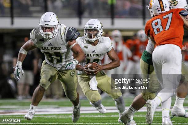 Quarterback Khaleel Jenkins follows the lead block of fullback Jared Mohamed of the Cal Poly Mustangs during second half action against the Idaho...