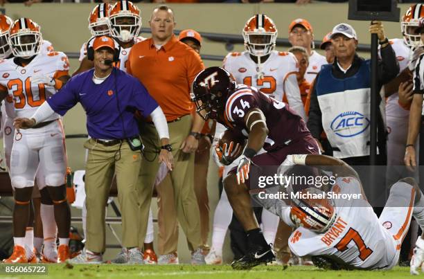 Travon McMillian of the Virginia Tech Hokies is tackled by Austin Bryant of the Clemson Tigers during the first quarter of their game at Lane Stadium...