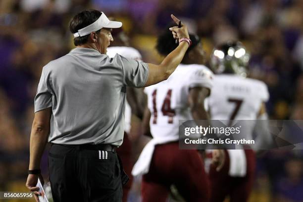 Head coach Neal Brown points to the locker room after a field goal to end the second quarter against the LSU Tigers at Tiger Stadium on September 30,...