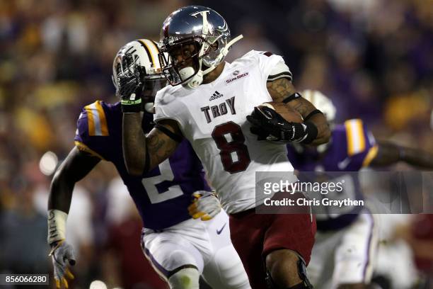 Emanuel Thompson of the Troy Trojans avoids a tackle by Kevin Toliver II of the LSU Tigers at Tiger Stadium on September 30, 2017 in Baton Rouge,...