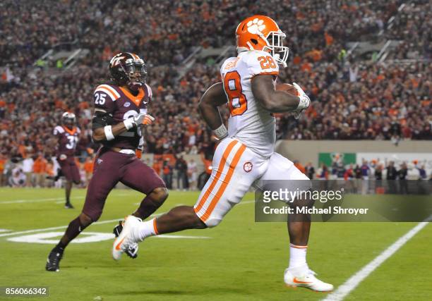 Tavien Feaster of the Clemson Tigers runs for a 60-yard touchdown after catching a pass from quarterback Kelly Bryant during the first quarter...