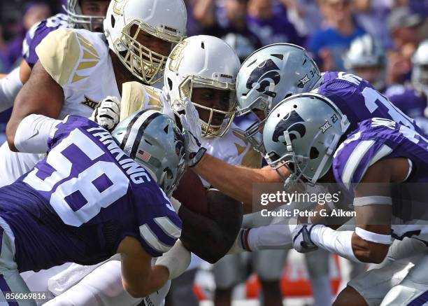 Linebacker Trent Tanking of the Kansas State Wildcats tackles running back Terence Williams of the Baylor Bears during the first half on September...