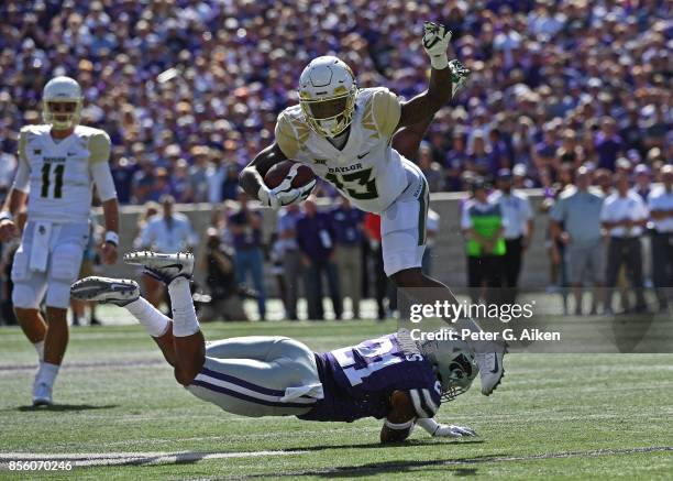 Free safety Kendall Adams of the Kansas State Wildcats trips up wide receiver Tony Nicholson of the Baylor Bears during the first half on September...