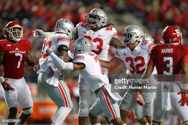 Linebacker Dante Booker of the Ohio State Buckeyes celebrates with teammates after intercepting a pass during a game against the Rutgers Scarlet...