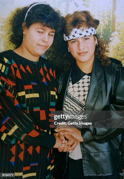 Palestinian woman suicide bomber Wafa Idris , wearing a Fatah headband and scarf, poses with an unidentified relative in this undated family...