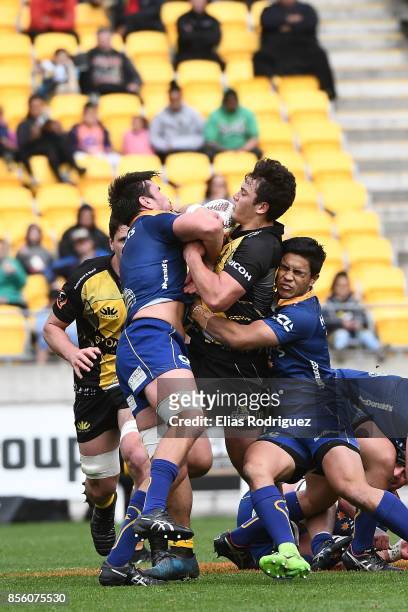 Adam Knight and Josh Loane of Otago tackle Thomas Umaga-Jensen of Wellington during the round seven Mitre 10 Cup match between Wellington and Otago...