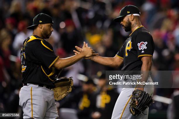 Elias Diaz and Felipe Rivero of the Pittsburgh Pirates celebrate after the Pirates defeated the Washington Nationals 4-1 at Nationals Park on...