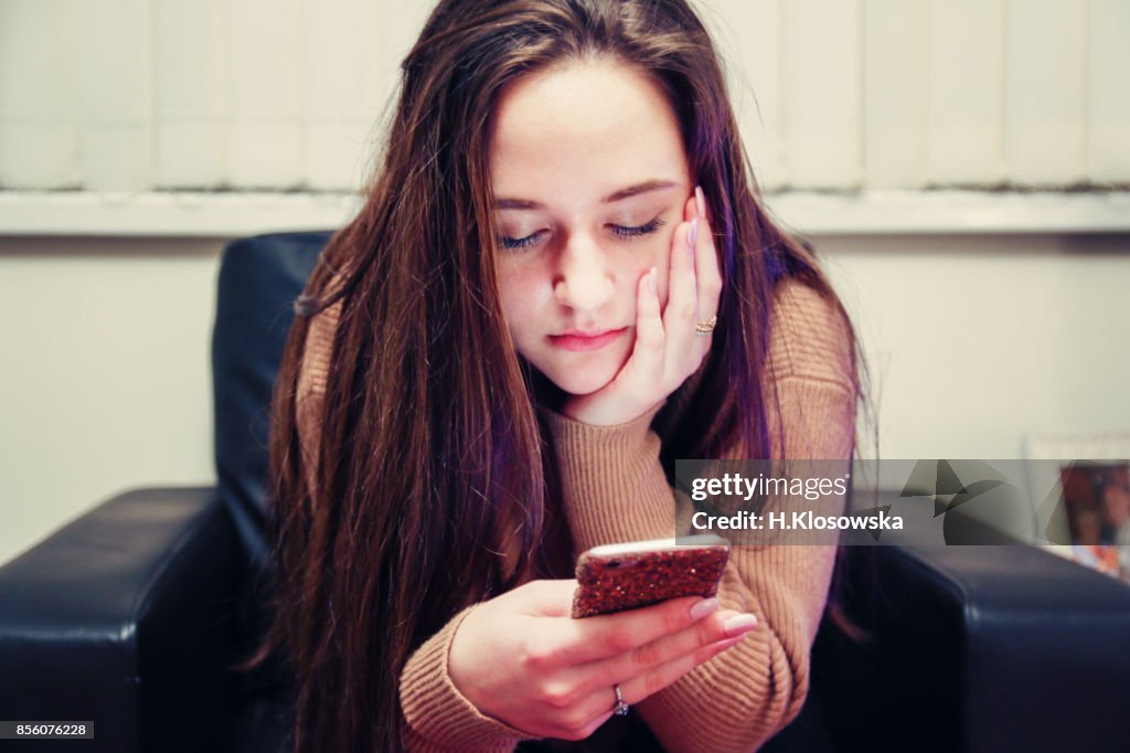 Teenage girl using her phone