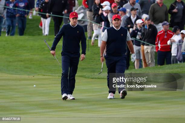 Golfers Jordan Spieth and Patrick Reed walk the 3rd hole during the third round of the Presidents Cup at Liberty National Golf Club on September 30,...