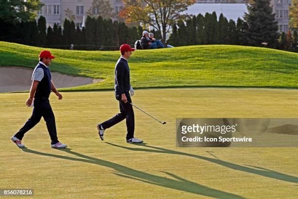 Golfers Jordan Spieth and Patrick Reed walk the 4th hole during the third round of the Presidents Cup at Liberty National Golf Club on September 30,...