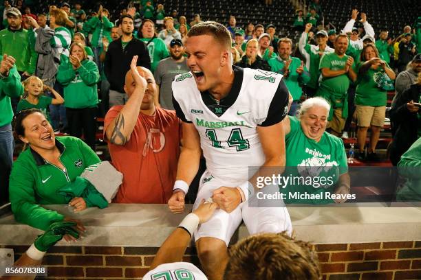 Chase Litton of the Marshall Thundering Herd celebrates with fans after defeating the Cincinnati Bearcats at Nippert Stadium on September 30, 2017 in...