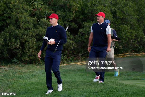 Golfers Jordan Spieth and Patrick Reed walk the 5th hole during the third round of the Presidents Cup at Liberty National Golf Club on September 30,...