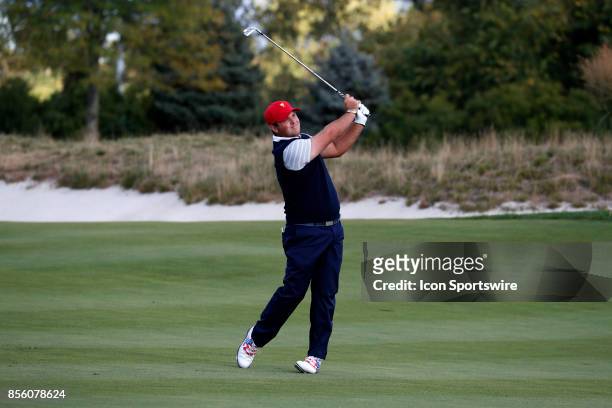 Golfer Patrick Reed hits an approach shot on the 6th hole during the third round of the Presidents Cup at Liberty National Golf Club on September 30,...
