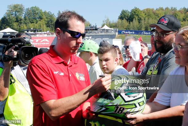 Kyle Busch, Monster Energy NASCAR Cup Series driver of the M&M's Caramel Toyota , signs an autograph during the Monster Energy Cup Series ISM Connect...