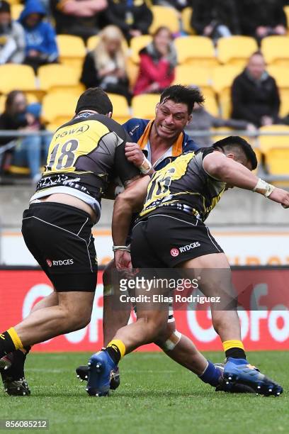 Mika Mafi of Otago runs into the tackle of Joe Apikotoa and Asafo Aumua of Wellington during the round seven Mitre 10 Cup match between Wellington...